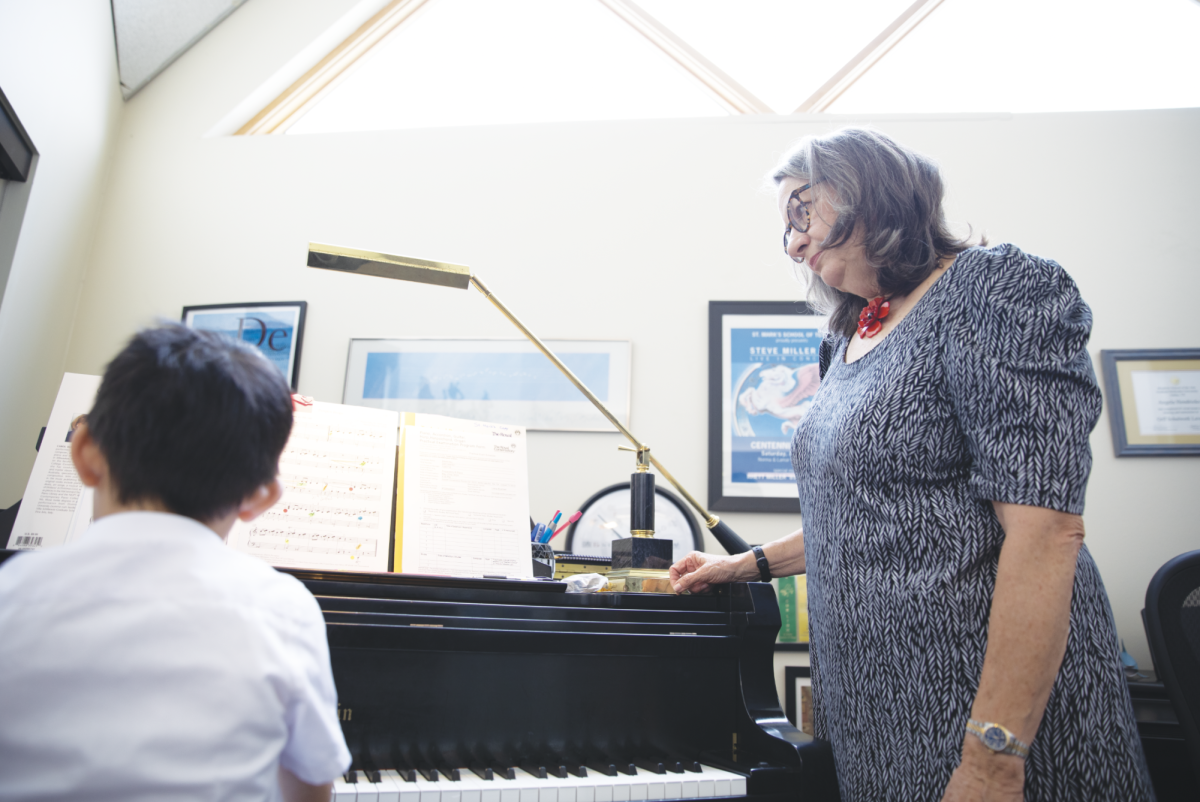 PRACTICE MAKES PERFECT Piano instructor Angela Hendricks guides a student through a piano piece.